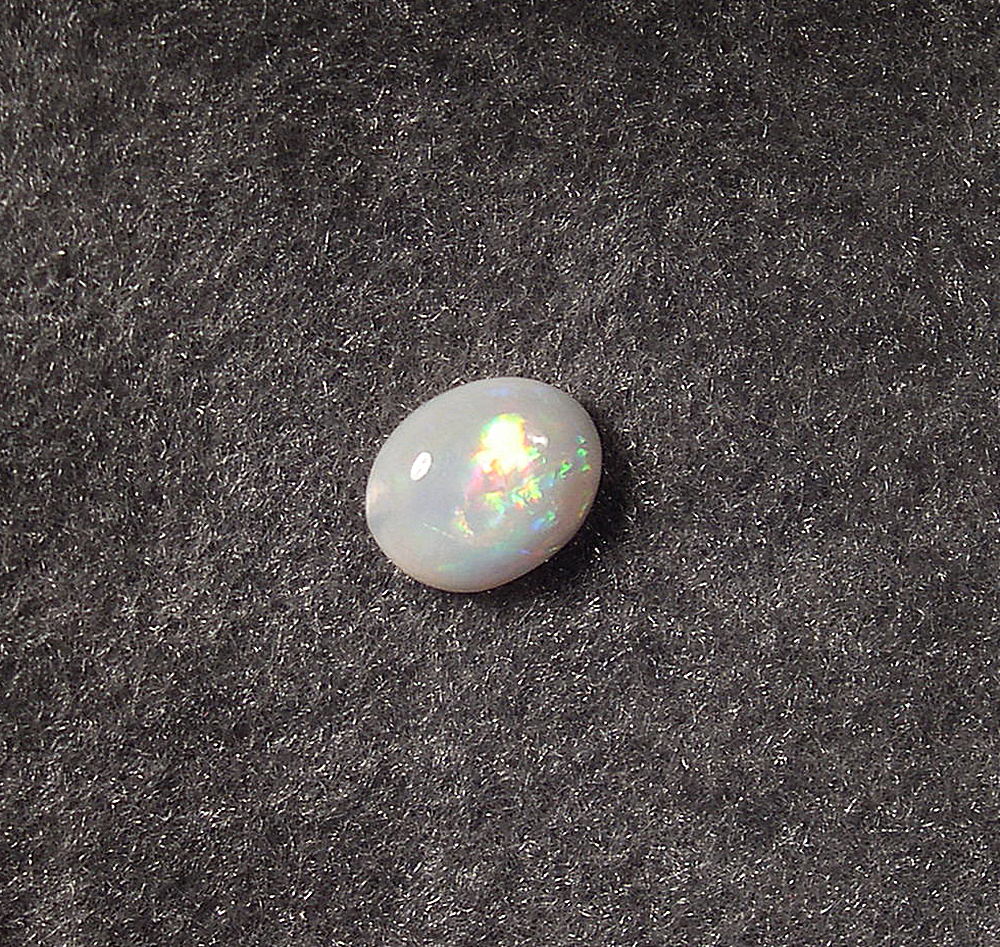 Bright rolling flash in this 9X11 solid white opal - OpalSmith